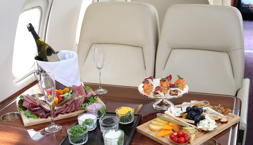 Tray with delicious food on the plane, business class travel